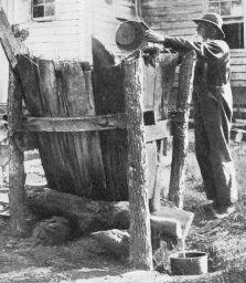 Colonial Soap Maker Leaching Lye in a Hopper